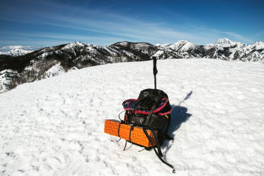 black and red stroller on snow covered ground